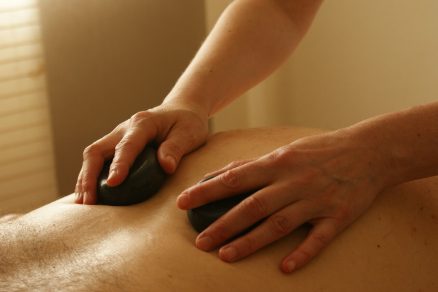 Pessoa recebendo massagem com pedras quentes